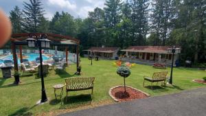 a yard with two chairs and a swimming pool at The Meadows in Lake George