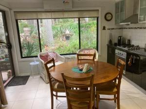 a kitchen with a wooden table and chairs in a room at Werekataba in Mount Hutton