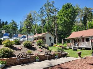 a yard with chairs and a fence and a house at The Meadows in Lake George