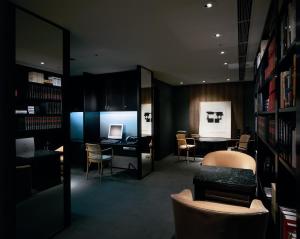 a room with a library with a table and chairs at Park Hyatt Tokyo in Tokyo