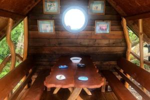 a table in the inside of a cabin with a window at River View Log Cabin Pod - 5 star Glamping Experience in Muff