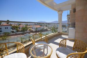 a balcony with chairs and a view of the city at YalaRent Eucalyptus 2BR & Balcony APT in Eilat