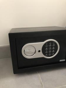 a black microwave with a control panel in a room at Le "Duo Sètois" in Sète