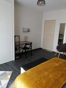 a bedroom with a bed and a table in it at DAL PAN BAZZO Sandrine in Berson +17 photos