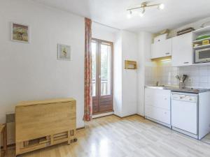 a kitchen with white cabinets and a sink and a window at Appartement Villard-de-Lans, 2 pièces, 4 personnes - FR-1-515-94 in Villard-de-Lans