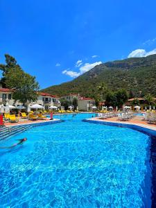 a swimming pool with a person swimming in the water at Sundia By Liberty Oludeniz in Oludeniz