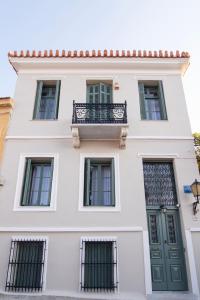 a white building with a balcony on it at Acron Athens in Athens