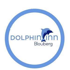 a dolphin in a circle logo at Dolphin Inn Blouberg in Bloubergstrand