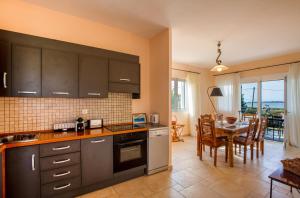 a kitchen and dining room with a table and chairs at Gyra Villas - Seaview Villa Fivos with private pool in Lefkada