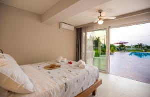 a bedroom with a bed and a view of a pool at Gyra Villas - Seaview Villa Fivos with private pool in Lefkada +39 photos