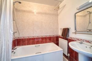 a bathroom with a tub and a sink at The George and Dragon in Dent