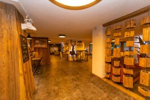 a room with wooden floors and a room with tables and chairs at Hotel Petit Palais in Breuil-Cervinia