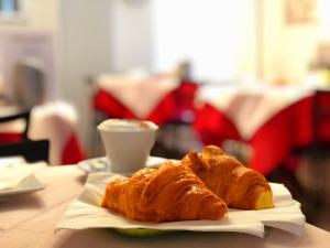 a plate of croissants and a cup of coffee on a table at Hotel Sanmicheli in Verona