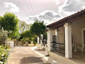 a house with a porch and a table on the side at Villa Maria 1 in Paleokastritsa
