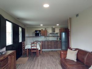 a living room with a table and a kitchen at Caserio OZAMIZ Urdaibai in Gautegiz Arteaga