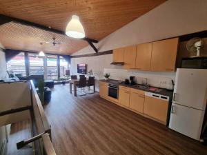 a kitchen and living room with a refrigerator and a table at SAV Ferienwohnung in Erfurt