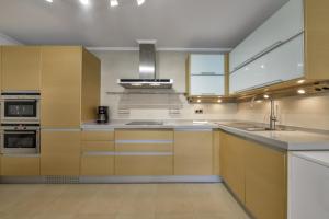 a large kitchen with a sink and a stove at Villas Guzman - Marjaleta in Moraira