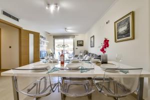 a dining room with a large white table and chairs at Villas Guzman - Marjaleta in Moraira