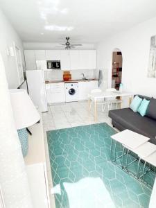 a living room with a couch and a kitchen at Karin's Beach Loft, Playa del Cura in Playa del Cura