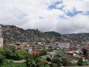 a view of a city with buildings on a hill at Mireya's 2BR Condo at Zone Vill - Burnham Park in Baguio