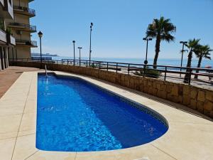 a swimming pool with the ocean in the background at PARADISE SUITES Buenavista Beach in Fuengirola
