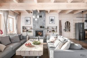 a living room with a couch and a table at Luxury Chalet Villa Gorsky Hanco & Janso in Poronin