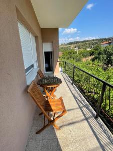 a balcony with a bench and a table at Entire 1-bedroom apartment with free parking in Podgorica