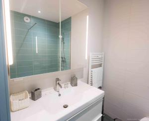 a bathroom with a white sink and a mirror at Chambres d'hôtes du Bistrot d'ici in Saint-Saturnin +29 photos