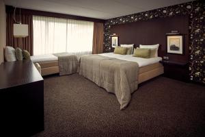 Postel nebo postele na pokoji v ubytování Van der Valk Hotel Emmeloord