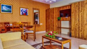 a living room with a couch and a table at HOTEL ROYAL GRANDE in Vellore