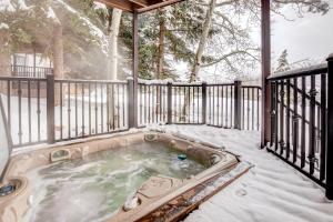 a hot tub on a deck in the snow at Pinnacle #1484 in Park City