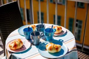 a table with plates of food and blue cups on it at SUEDE 2 AP4208 By Riviera Holiday Homes in Nice