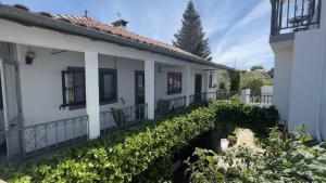 a white house with a balcony at Casa do Beco B&B Douro - Guest House in Parambos