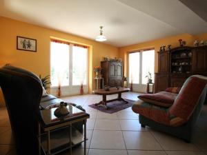 a living room with a couch and a table at Gîte Rauret, 4 pièces, 7 personnes - FR-1-582-203 in Rauret