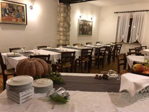 a dining room with white tables and chairs with pumpkins on them at Agriturismo DonnoMarco in Simeri +21 photos