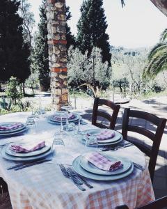 a table with plates and glasses on top of it at Agriturismo DonnoMarco in Simeri