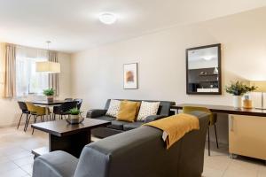 a living room with a couch and a table at Ponent 602 in Marina Portorož by Locap Group in Portorož