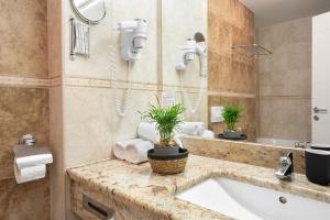 a bathroom with a sink and a bath tub at Ponent 602 in Marina Portorož by Locap Group in Portorož +15 photos