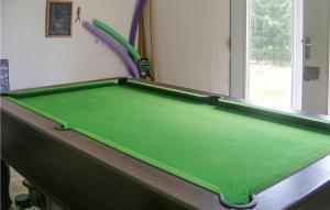 a green pool table in a room with at Amazing Home In St-hilaires-les-places With Wifi, Outdoor Swimming Pool And Swimming Pool in Sallas