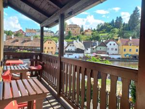 a dining room with a balcony overlooking a city at Hostel Merlin in Český Krumlov