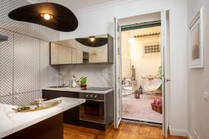 a kitchen with a sink and a shower backdoor at Casavignoni luxury apartment with terrace in Rome