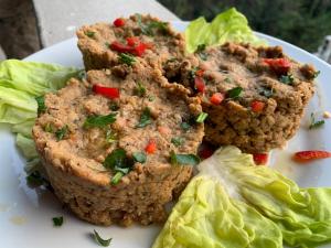 a plate of food with lettuce and meatballs at Skadar Lake Family Resort in Rijeka Crnojevića