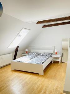 a white bedroom with a bed and two tables at aday - City Central Mansion - 4 bedroom apartment in Aalborg