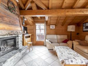a living room with a fireplace in a log cabin at Chalet Courchevel 1650, 6 pièces, 8 personnes - FR-1-514-69 in Courchevel