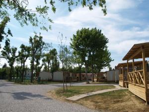 a house with a fence and trees at Camping Venezia Village in Mestre