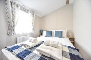 a bedroom with a large bed with towels on it at Hope View at Ashbourne Heights in Ashbourne