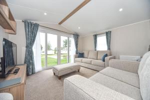 a living room with a couch and a tv at Hope View at Ashbourne Heights in Ashbourne