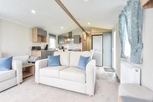 a living room with two couches and a kitchen at Hope View at Ashbourne Heights in Ashbourne