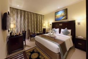 a bedroom with a large bed in a hotel room at Smana Hotel Al Raffa in Dubai