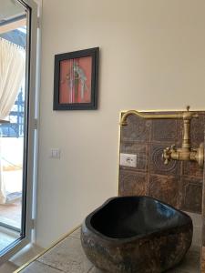 a bathroom with a large rock tub on the floor at Regal House Anzio Terrazzo in Anzio